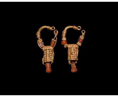 2nd century BC-1st century AD. A matched pair of gold earrings, each a penannular hoop with coiled filigree detailing, granul