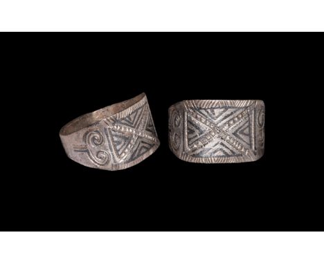 9th-11th century AD. A silver finger ring comprising flat-section hoop, flared shoulders each with scroll motif, rectangular 