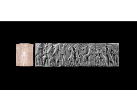 2334-2000 BC. A rock crystal cylinder seal with frieze depicting contest scenes: a rearing lion attacking a rearing goat, two