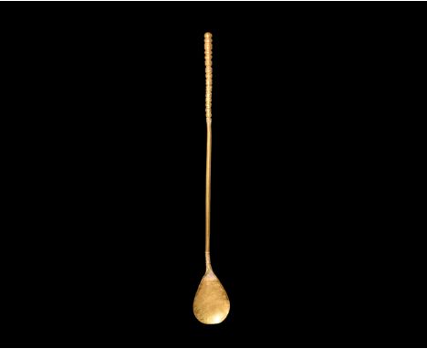 1st-2nd century AD. A slender gold spoon with shallow piriform bowl, round-section shank with ribbed detailing to each end, k