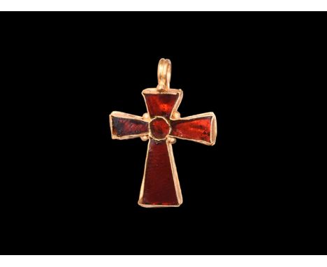 5th-7th century AD. A gold cross pendant with bifid suspension loop and granule, four trapezoidal arms each with a garnet clo