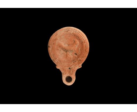 1st century AD. A ceramic oil lamp, decorated to the centre of discus with a standing cockerel; small filler hole towards the