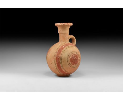 12th-10th century BC. A terracotta globular jug with basal ring, trumpet-shaped neck with median fillet, everted and chamfere