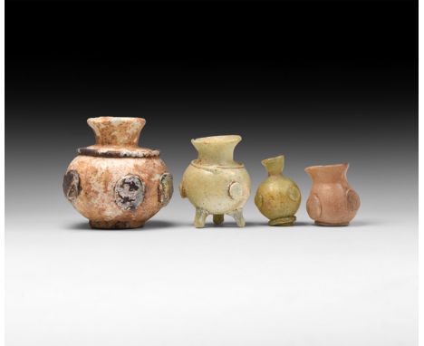 7th century AD. A group of glass vessels with flaring neck and globular body with applied roundels to the side; three with ri