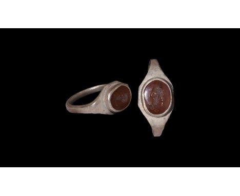 2nd-3rd century AD. A silver finger rig with square-section hoop, flat scaphoid bezel with cell, inset carnelian cloison with