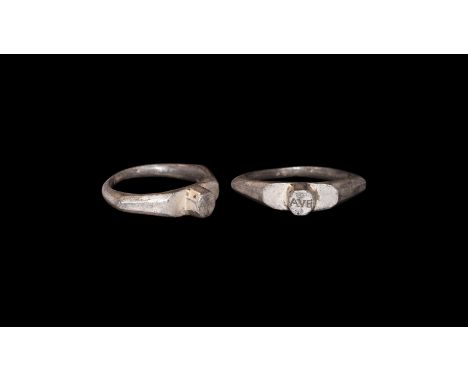 3rd century AD. A silver finger ring with tapering D-section hoop, acute facetted shoulders, plaque with central octagonal st