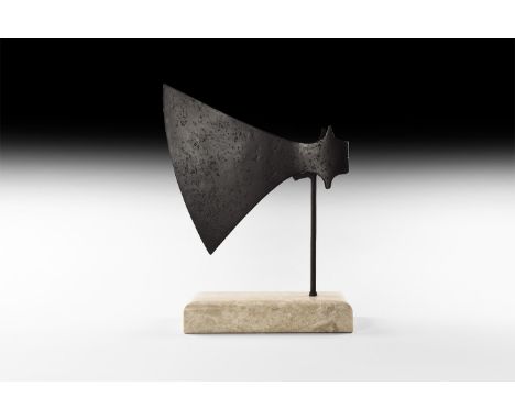 9th-11th century AD. A hand-forged iron axehead with triangular-section blade, narrow neck widening to a broad curved bevelle