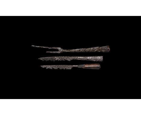 13th-15th century AD. An iron cutlery group comprising: a table knife with slender blade, scale-tang construction with bone s