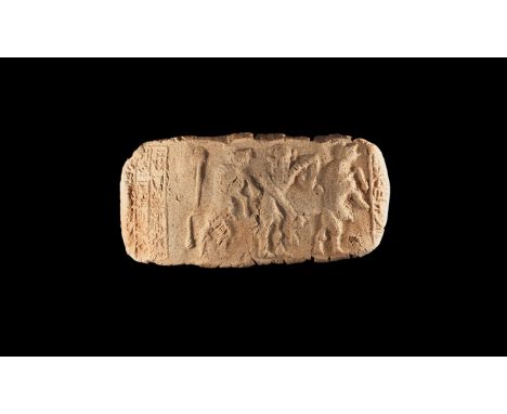 22nd-20th century BC. A rectangular ceramic cylinder seal impression with a central motif of a 'bull-man' holding a tail of a