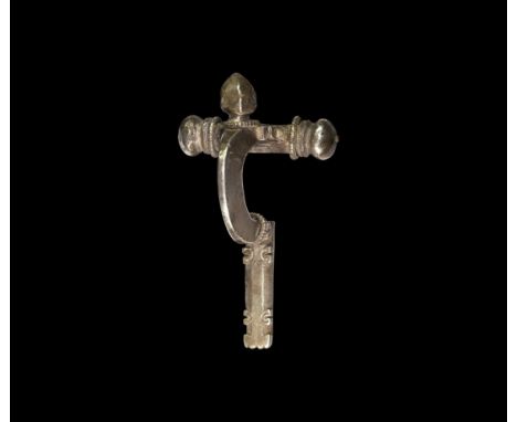 4th century AD. A silver crossbow brooch with tubular crossbar, three onion-shaped knops with beaded collars, deep trapezoida