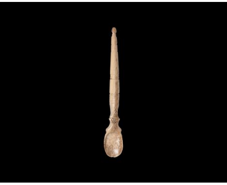 5th-9th century AD. A carved bone spoon with tapering round-section handle and knop finial, volute scroll neck, shallow oval 