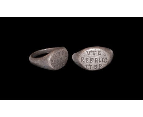 2nd century AD. A silver finger ring with D-section hoop, ellipsoid bezel with incised text 'VTE/REFELIC/ITER' (use [this] ha