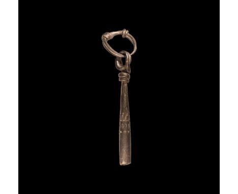9th-11th century AD. A silver cigar-shaped pendant with looped and coiled finial, bands of stamped decoration to the shaft, s