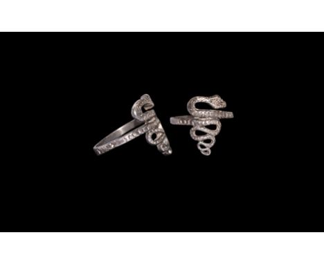 1st century BC. A silver finger ring formed as a cast square-section hoop with meandering head and tail, scale detailing. Cf.