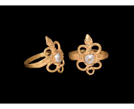 Roman Period, 30 BC-323 AD. A gold finger ring comprising two conjoined hoops, S-curved serpent body with granules and snake-