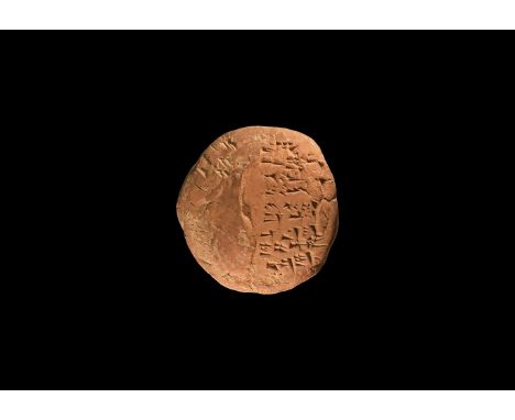 Ur III, 22nd - 21st century BC. A plano-convex ceramic block with incised cuneiform text to the flat underside and part of th