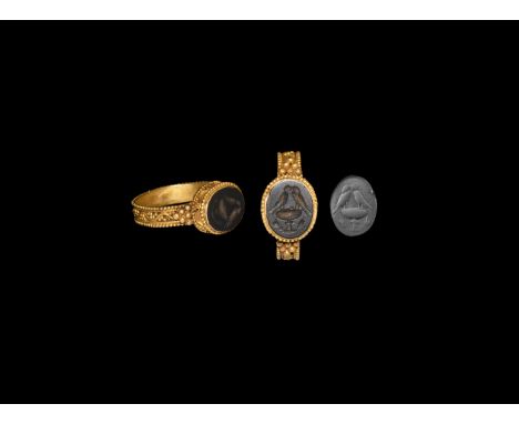 1st century BC-1st century AD. A black jasper cloison with intaglio image of two confronted birds on a chalice; set into a go