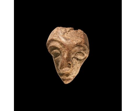 Pliocene Period, 5.2 - 2.5 million years BP. A mastodon fossil bone with later facial carving, from the island of Java. 89 gr