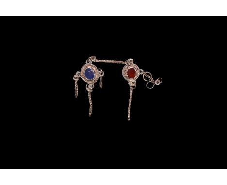 1st-2nd century AD. Silver bracelet fragments with distributor and chain linking discoid plaques, one with blue glass cloison