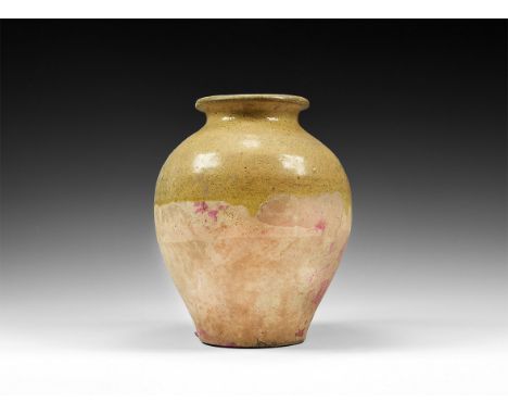 Tang Dynasty, 618-906 AD. A ceramic jar with piriform body, flat base, broad neck with everted rim, partly glazed. 1 kg, 20.5