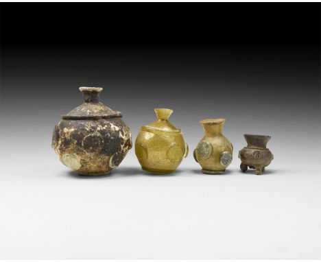 10th-12th century AD. A group of glass vessels consisting: two with flared rim and short neck, applied band to the shoulder, 