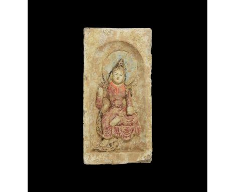 Northern Wei Dynasty, 386-534 AD. A ceramic brick with recess to one face, nimbate figure of Buddha with one hand raised seat