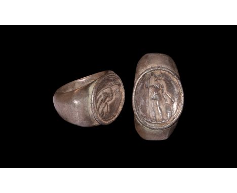 2nd-3rd century AD. A silver finger ring with D-section hoop, facetted shoulders, central cell with ropework border, image of