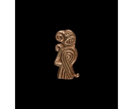 5th-6th century AD. A silver-gilt plate brooch of a stylised bird with coiled beak, three-strand wing, tail and shoulder, cur