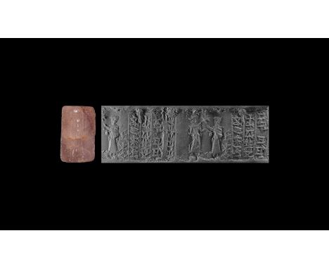 19th-16th century BC. A carved amethyst cylinder seal with figural frieze and owner's inscription; accompanied by a museum-qu