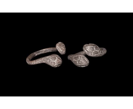 1st century AD. A silver ring with round section hoop, the shank engraved with a series of hatched lines to represent scales;