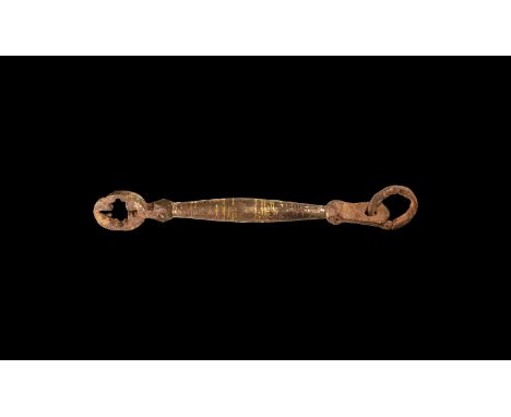 9th-11th century AD. An iron latchlifter key with pierced discoid plate, fusiform shaft with bands of laten inlay, pierced fi