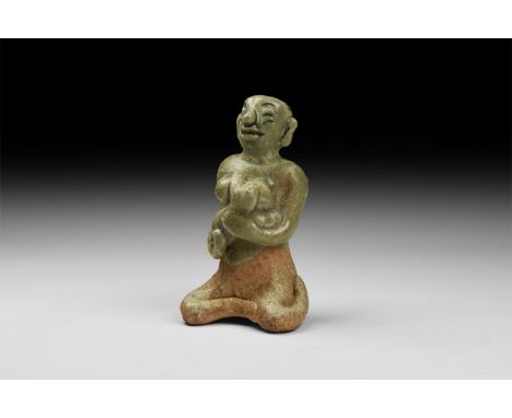 14th-16th century AD. A green-glazed ceramic figurine of a nude seated female suckling a baby in her arms. 164 grams, 10cm (4