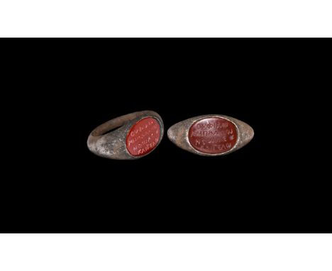 3rd century AD. A silver finger ring comprising D-section hoop, angled shoulders, discoid plaque with inset carnelian cloison