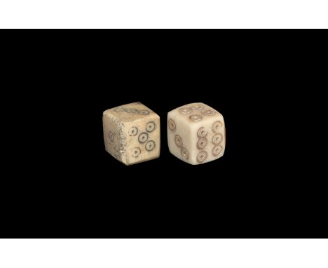 1st-3rd century AD. A pair of cuboid bone dice, ring-and-dot spots to each face arranged 6:1, 2:5, 3:4 on one and 6:1, 2:4, 3