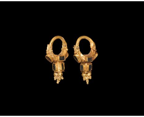 2nd century BC-2nd century AD. A matched pair of gold earrings, each a hinged hoop, hollow-formed drop body with applied gran