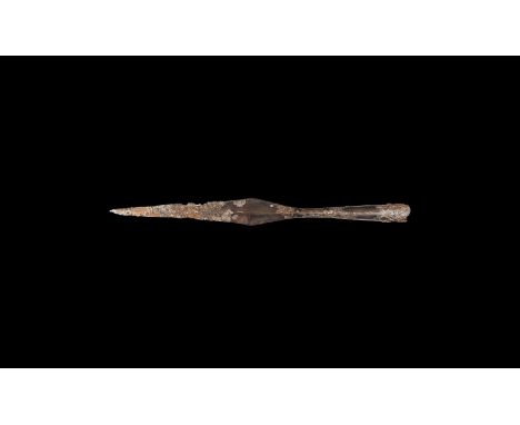 9th-11th century AD. An iron spearhead with slender tapering lozenge-section blade, long closed socket with hole to accept an