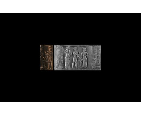 1900-1530 BC. A haematite cylinder seal with figural scene and two columns of cuneiform text: the suppliant goddess Lama (wit