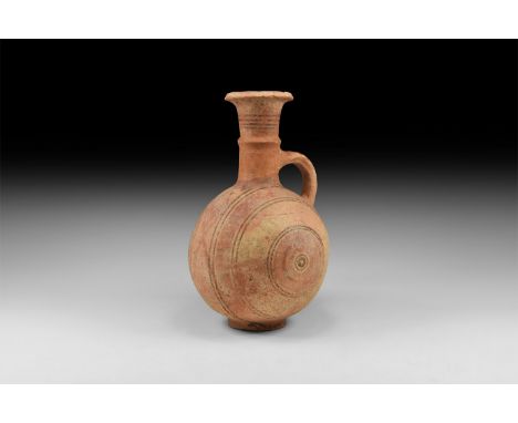 12th-10th century BC. A terracotta globular jug with basal ring, trumpet-shaped neck with median fillet, everted and chamfere