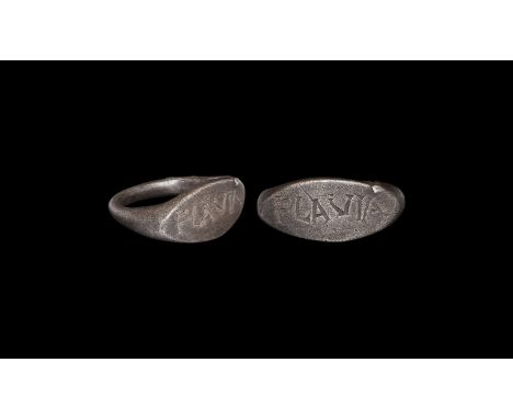 1st century AD. A silver finger ring with round-section hoop, scaphoid bezel with incised inscription 'FLAVIA'. Cf. Chadour, 