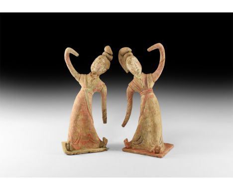 Tang Dynasty, 618-907 AD. A ceramic pair of figures depicting dancers with hair pulled up into a bun at the top of the head, 