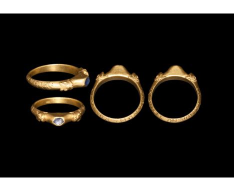 14th century AD. A gold finger ring comprising a cusped D-section hoop with shoulders formed as facing beast-heads with trian