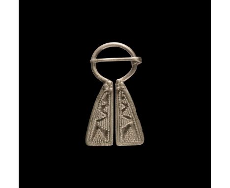 8th-12th century AD. A silver Mordvinian omega-shaped brooch with granule decoration in the form of triangles; pin coiled to 