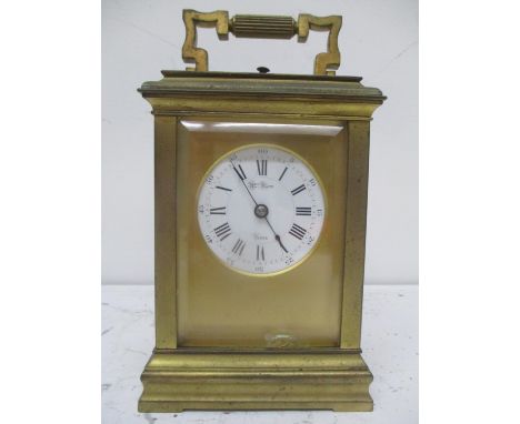 A 19th century French Henry Marc repeater carriage clock in a brass case and having a white enamel with Roman numerals, 7 1/4