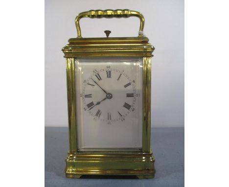 A late 19th/early 20th century French brass repeater carriage clock having a white enamel dial with Roman numerals and blued 