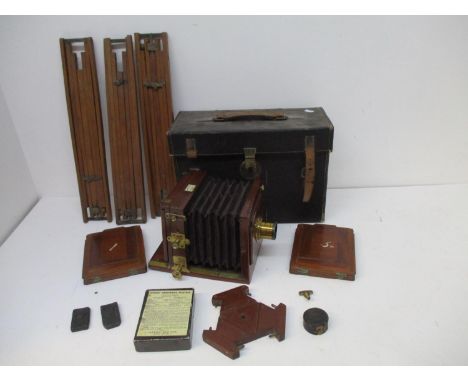 A Hunter &amp; Sands, London mahogany and brass plate camera and accessories, to include a tripod, a black leather carrying c