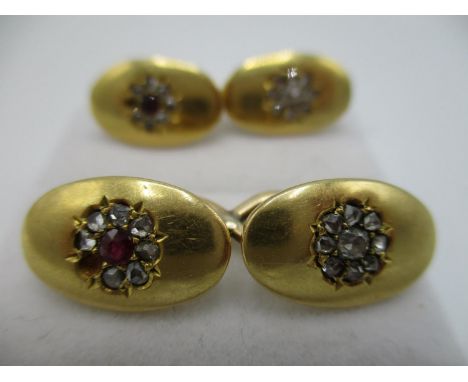 A pair of 18ct gold oval cuff links inset with diamonds and ruby flower design, total weight4.9g 