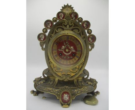 A 19th century French brass mantle clock, the painted dial having Roman numerals and signed T A Simpson &amp; Co, Paris. The 