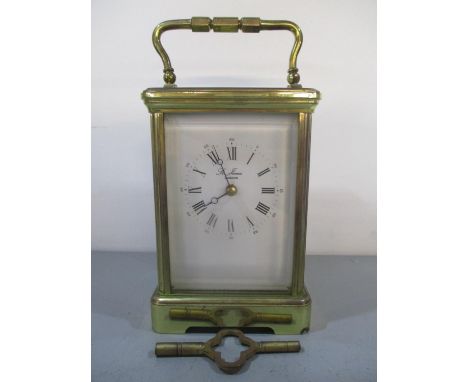 A mid 20th century brass carriage clock, the white enamel dial inscribed St James, London and having black Roman numerals. Th