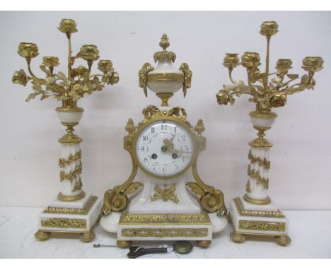 A 19th century French gilt metal mounted and white marble clock garniture. The convex dial having Arabic numerals, pierced gi