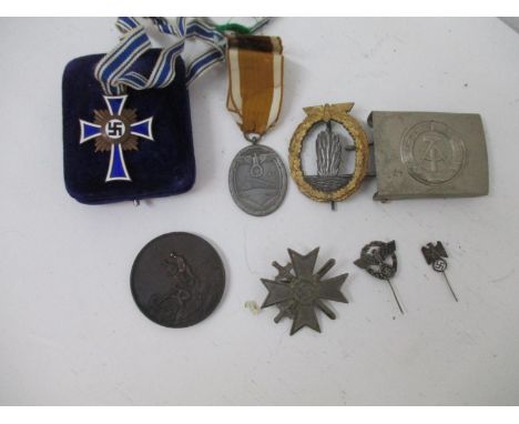 Mainly German military regalia to include a mid 20th century buckle with a hammer and compass insignia, a FurArbeit Zum Schut